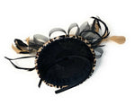 Leopard print velvet mini disc fascinator mounted on a black headband from the back