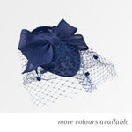 Teardrop pointed pillbox fascinator hat with birdcage veil and feather trim on headband