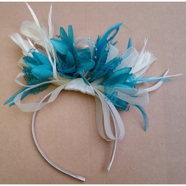 New turquoise fascinator with white netting and barb deals quills on a headband! Made to order!